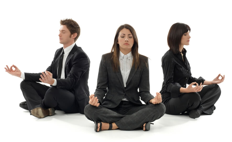 Corporate employees practicing yoga in an office setting