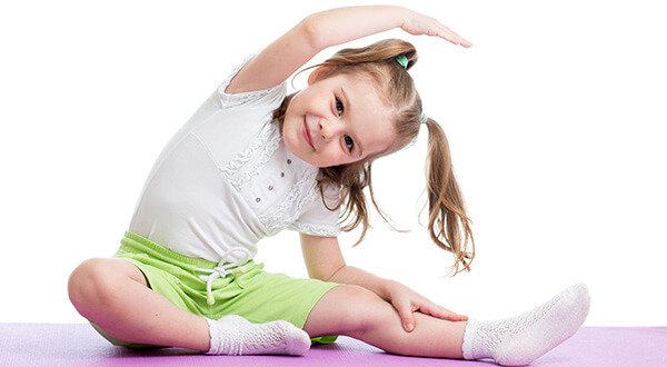 Children practicing classical Hatha Yoga asanas in a kids yoga class