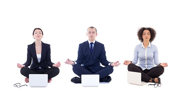Corporate yoga class with instructor guiding employees