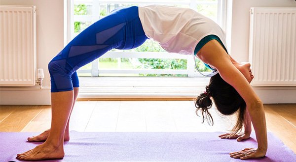 Woman doing yoga asanas for hormonal balance and stress relief