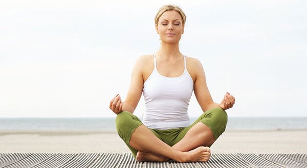 Pregnant woman performing gentle prenatal yoga stretches