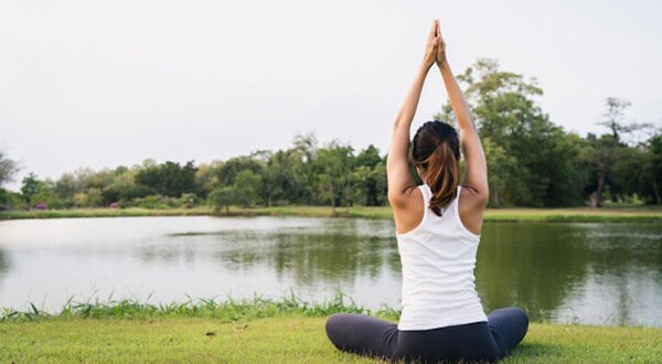 A woman practicing beginner yoga poses on a mat